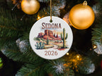 Round ornament depicting Sedona, Arizona landscape with "SEDONA 2026" text.
