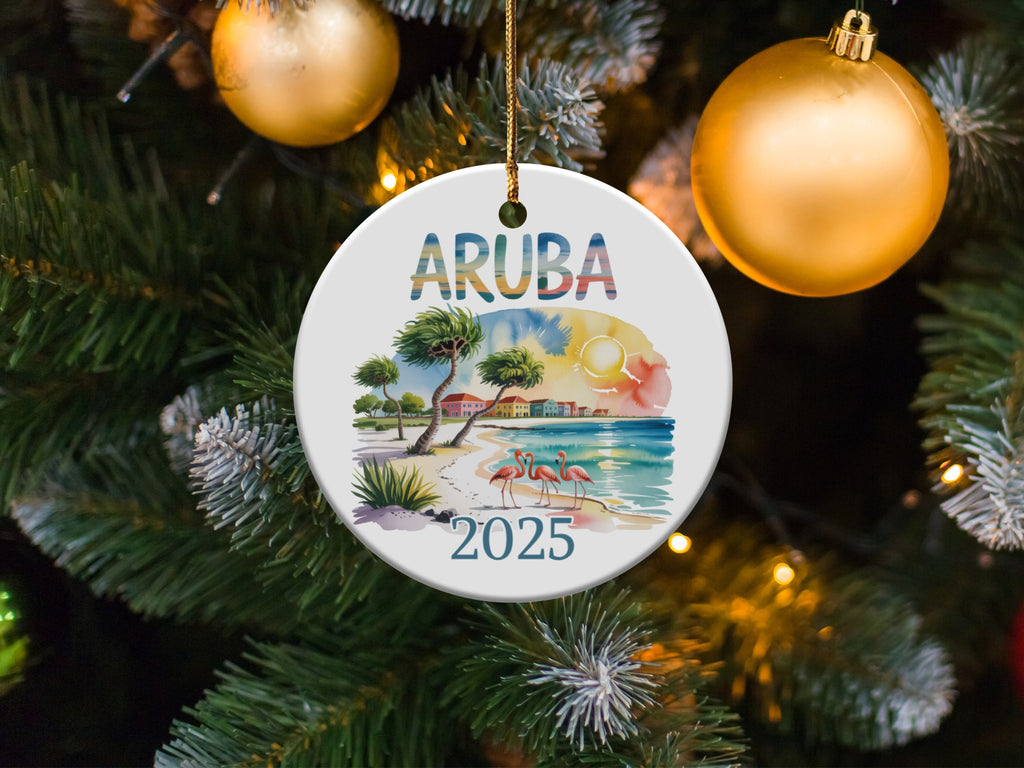 Round ceramic ornament with "ARUBA 2025" text, flamingos, and beach scene.