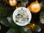 Round ceramic ornament with "ARUBA 2025" text, flamingos, and beach scene.