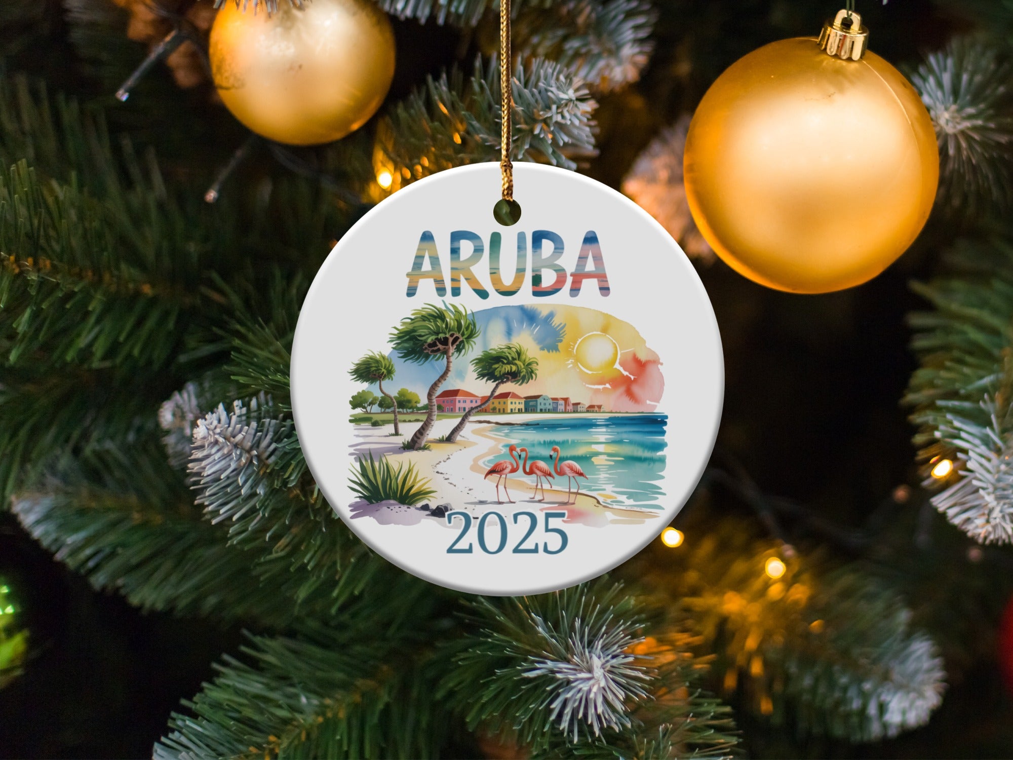 Round ceramic ornament with "ARUBA 2025" text, flamingos, and beach scene.