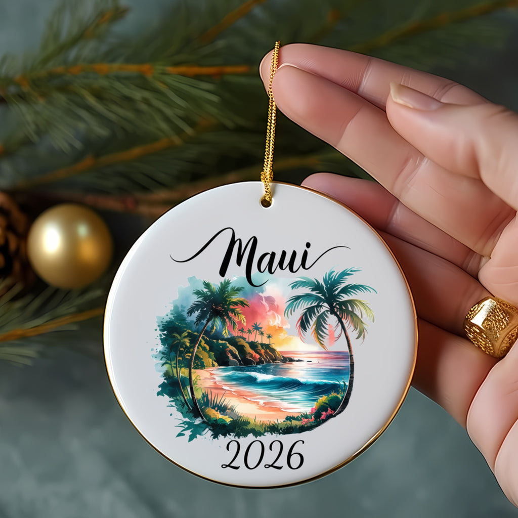 Round ornament with a tropical beach scene and "Maui 2026" text.