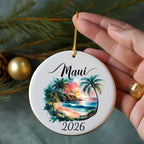 Round ornament with a tropical beach scene and "Maui 2026" text.