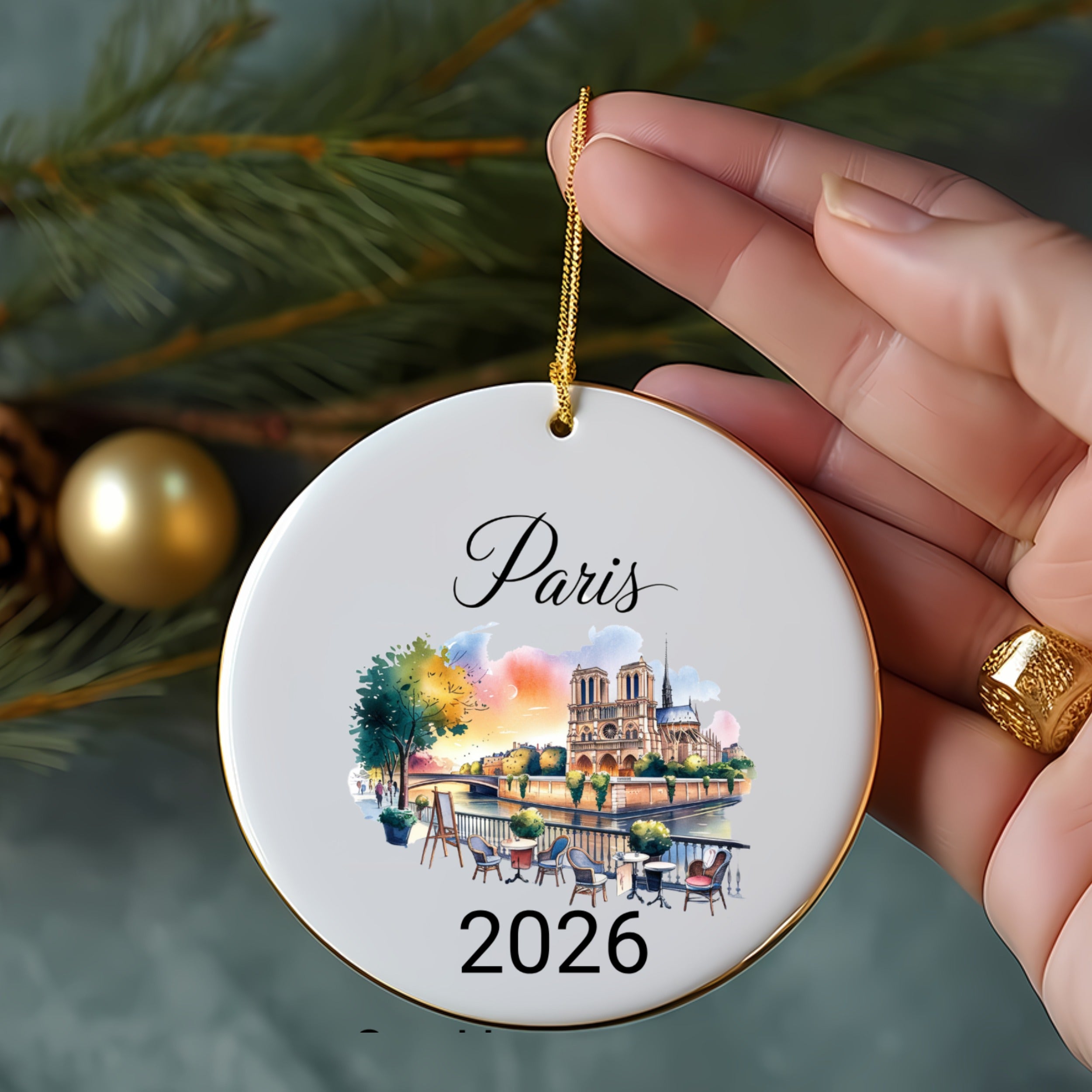 Round ceramic ornament with Paris illustration and "2026" text.