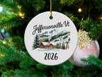 Round ornament with "Jeffersonville Vt 2026" and mountain cabin scene.