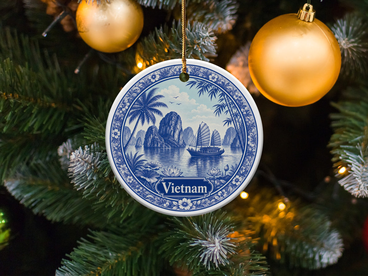 Blue and white ceramic ornament depicting a Vietnamese landscape with sails and text "Vietnam".