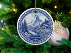 Blue and white ceramic ornament featuring a Swiss mountain village scene and the word "Switzerland".