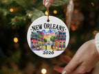 Round ornament with colorful New Orleans street scene and "New Orleans 2026"
