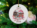 Round ornament with Kyoto landmark and pink cherry blossoms, hangs on Christmas tree.