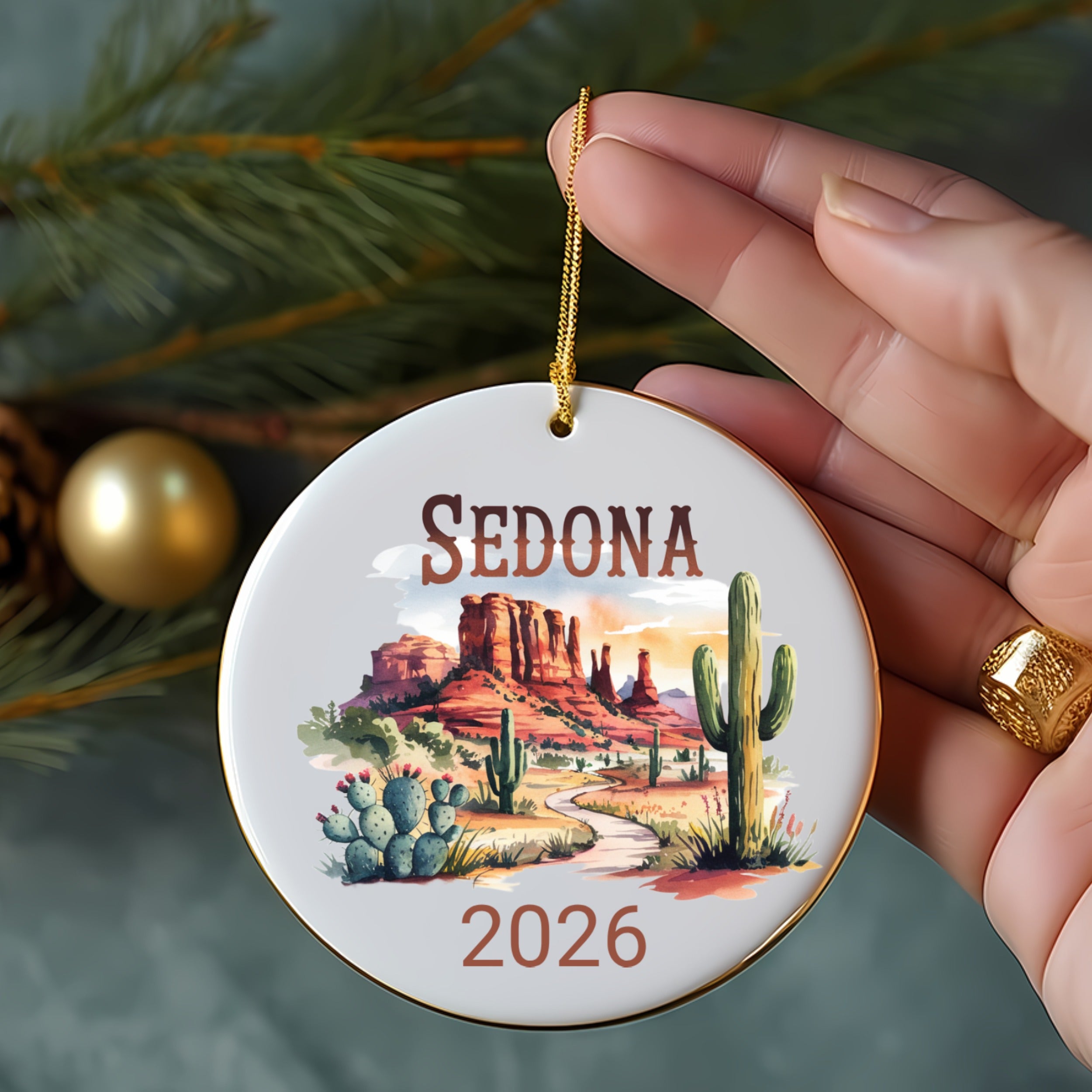 Round Sedona ornament with desert landscape, cactus, and "2026".