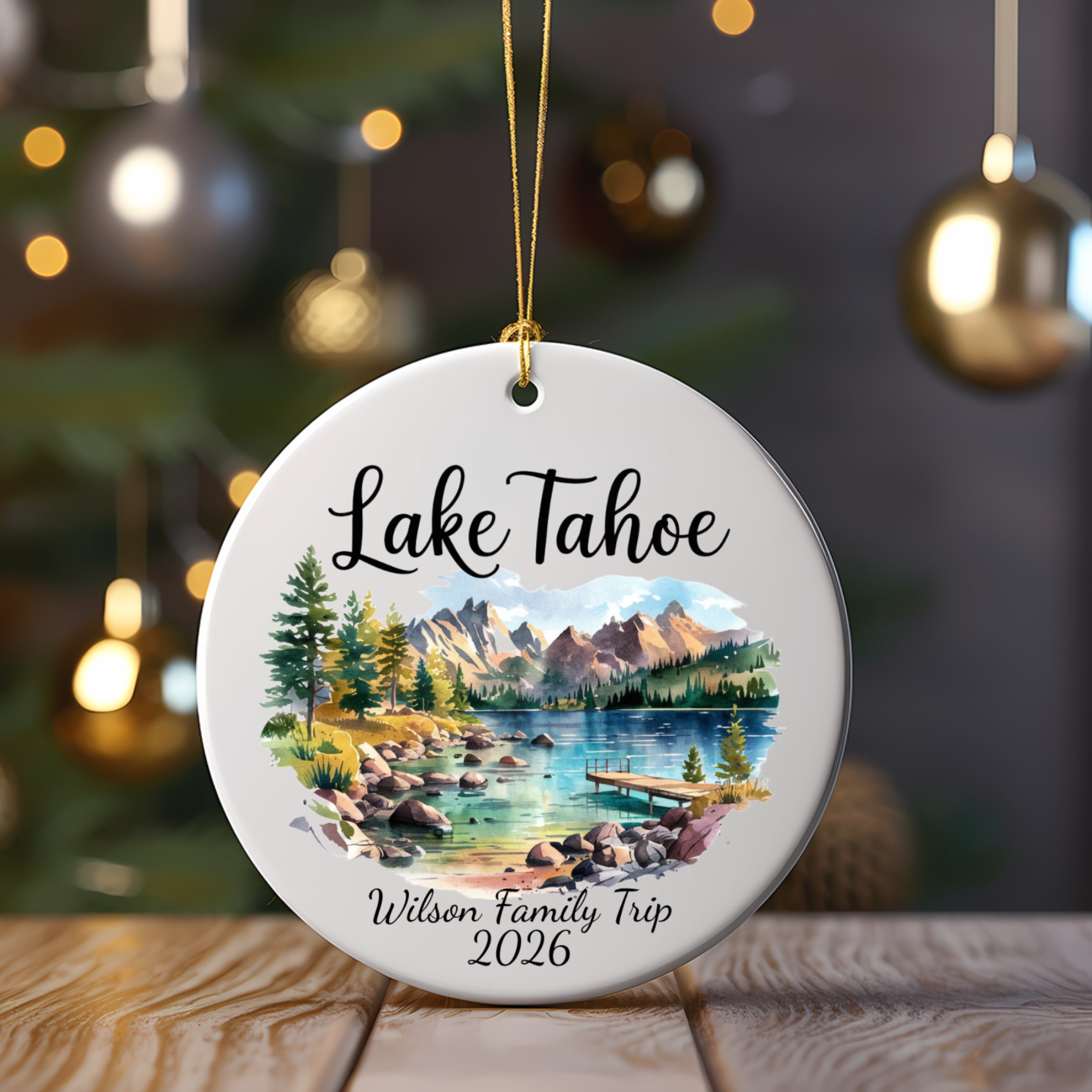 Round ceramic ornament featuring Lake Tahoe scene with personalized text "Wilson Family Trip 2026".