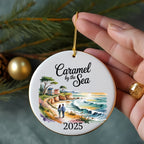 Ornament with "Caramel by the Sea 2025" and a coastal scene.