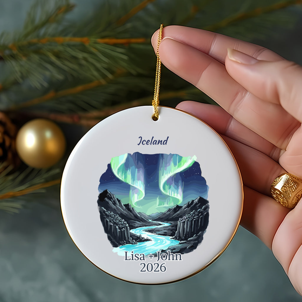 Round ornament with Iceland and aurora borealis scene, personalized with names and year.
