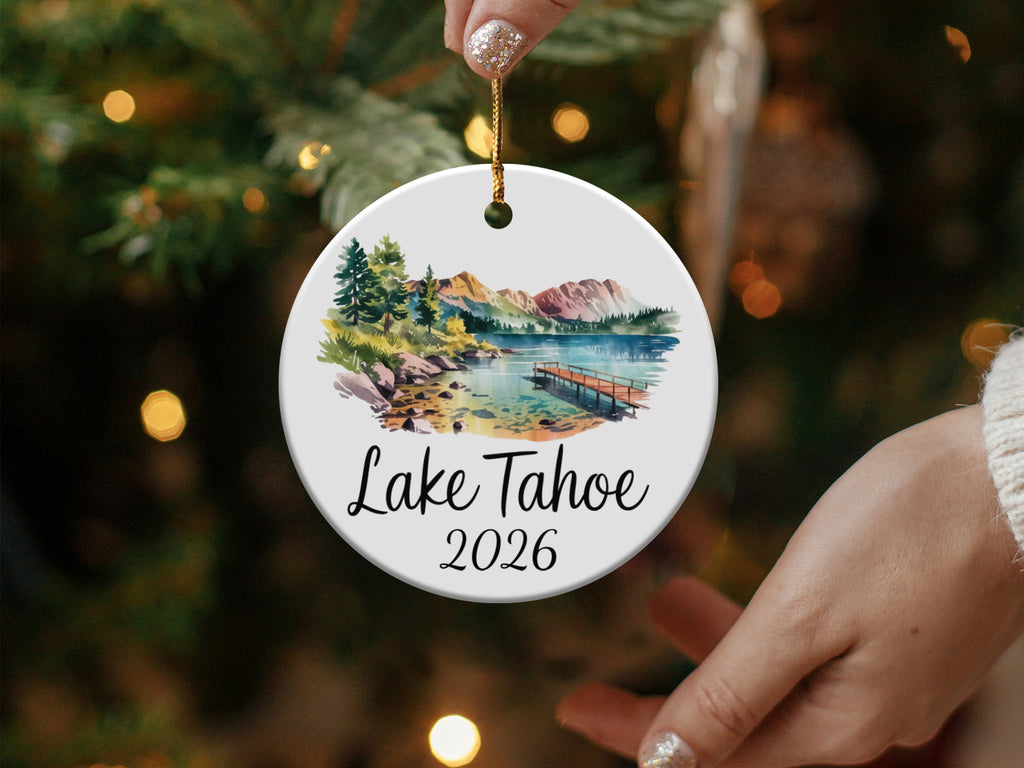 Round ceramic ornament with Lake Tahoe scene and mountains.