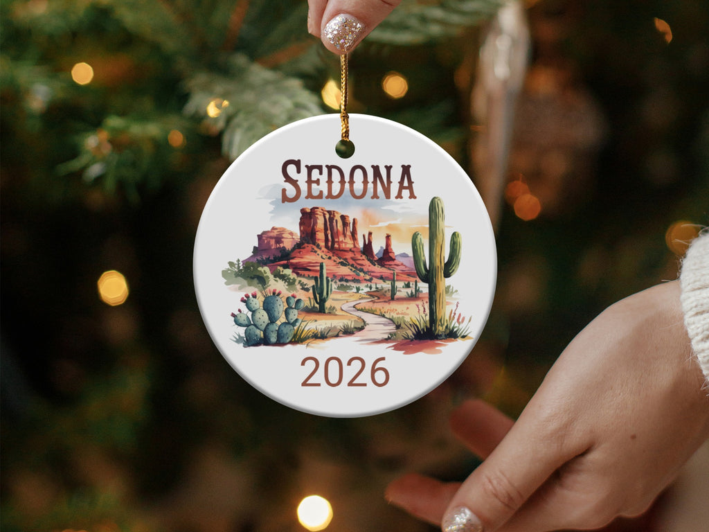 Round Sedona 2026 ornament featuring desert landscape and saguaro cacti.