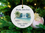 Ornament with tropical waterfall scene, palm trees, and personalized text.