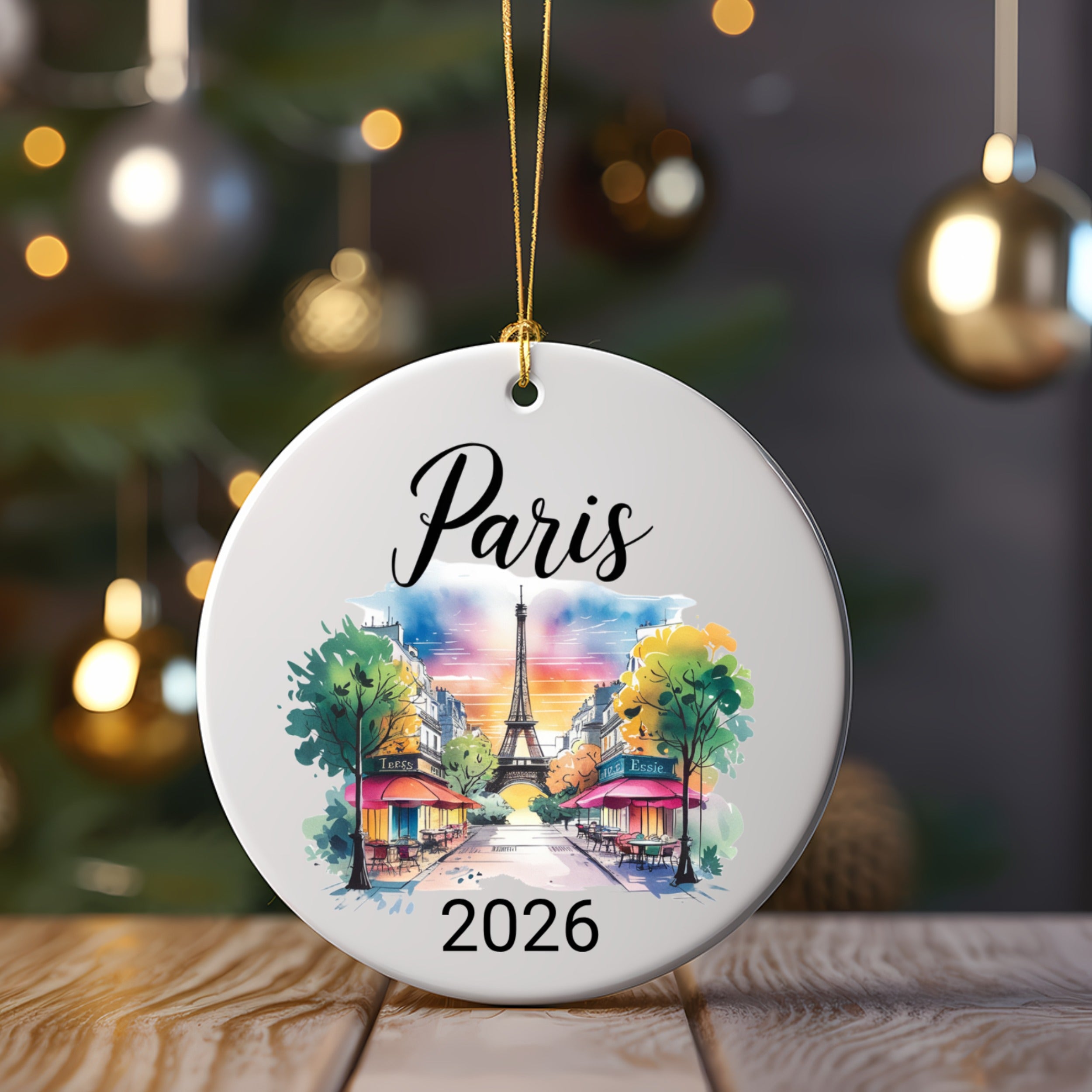 Round ornament with Paris skyline illustration and "2026" text.