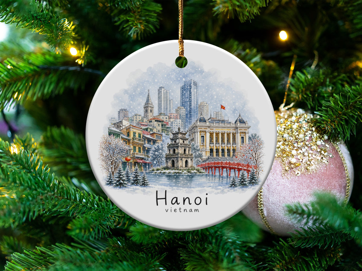 Round ornament featuring a watercolor scene of Hanoi, Vietnam with text.