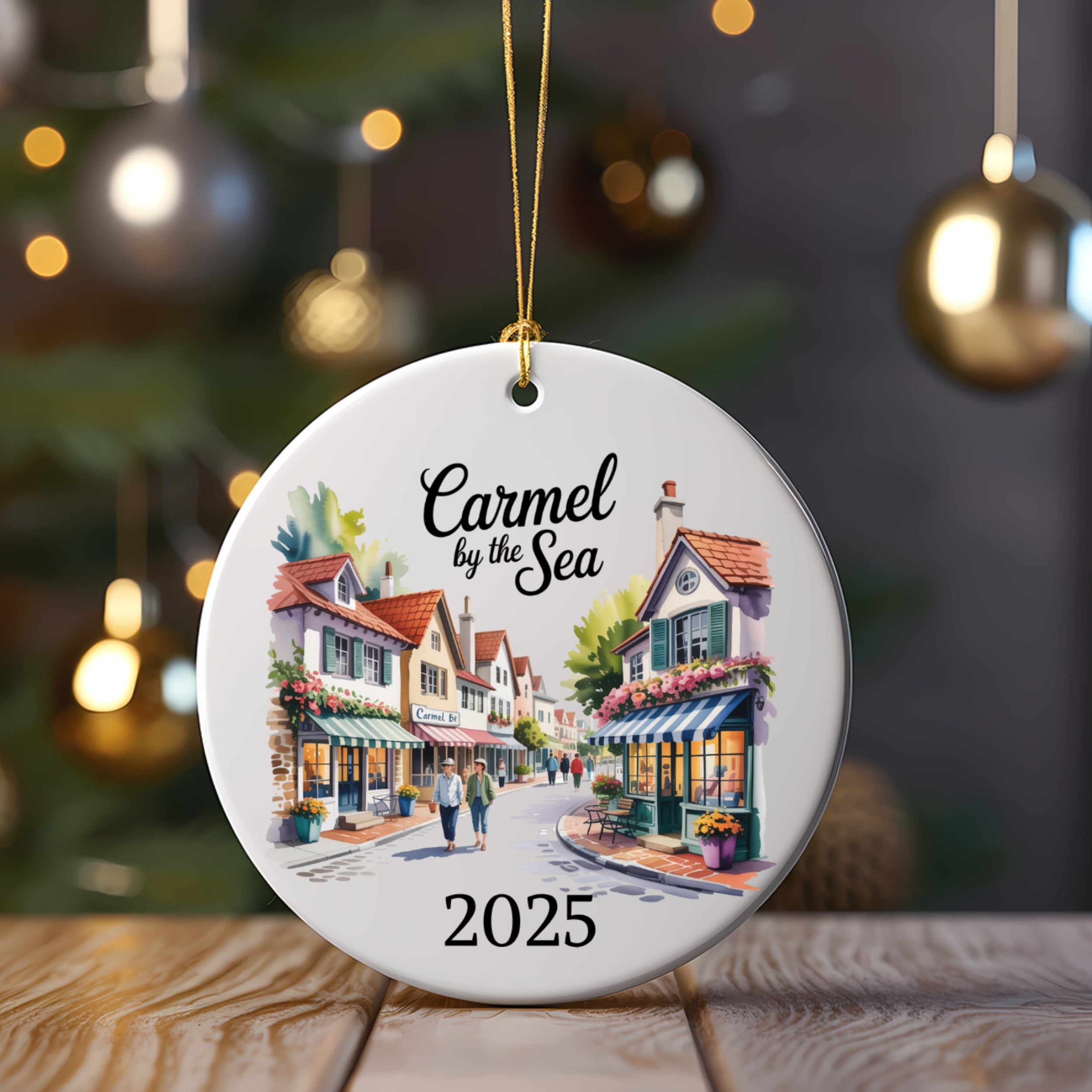 Ornament with watercolor painting of Carmel by the Sea storefronts and "2025".