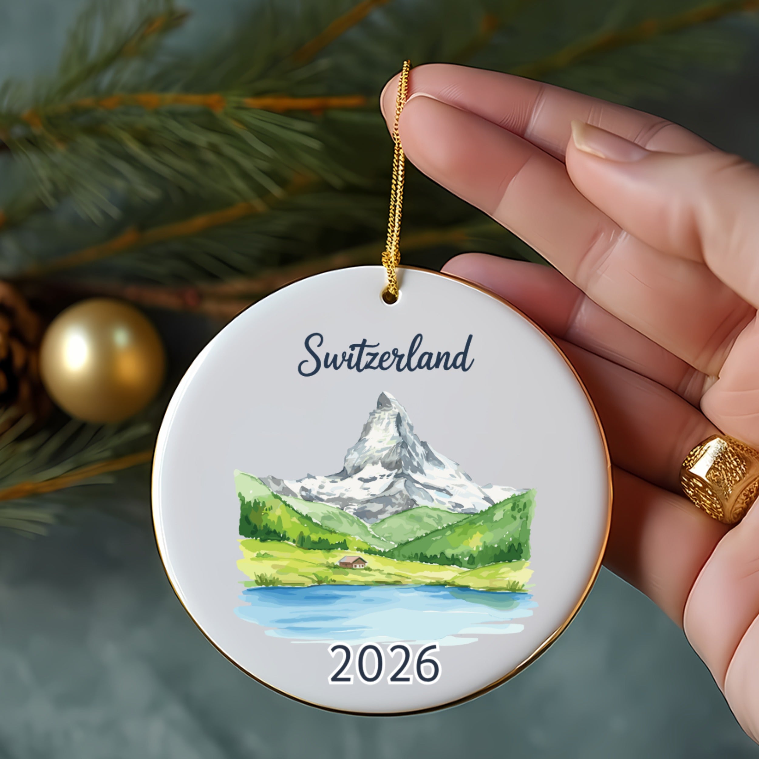Switzerland ornament with Matterhorn, lake, and pine trees, dated 2026.