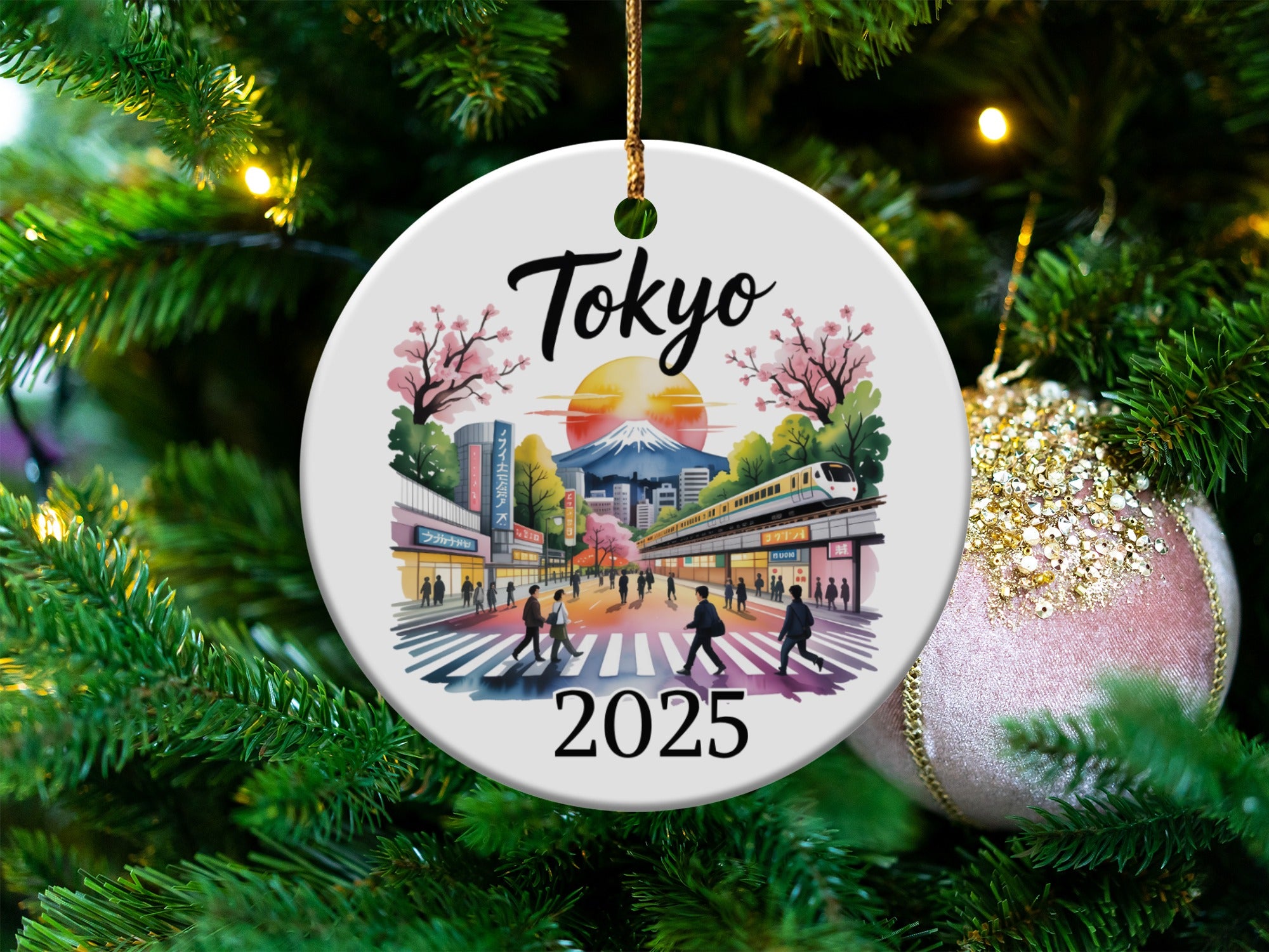 Round ornament with Tokyo 2025 scene, including train, buildings, and Mount Fuji.