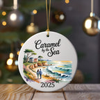 Caramel by the Sea 2025 ornament featuring a coastal scene with a couple.