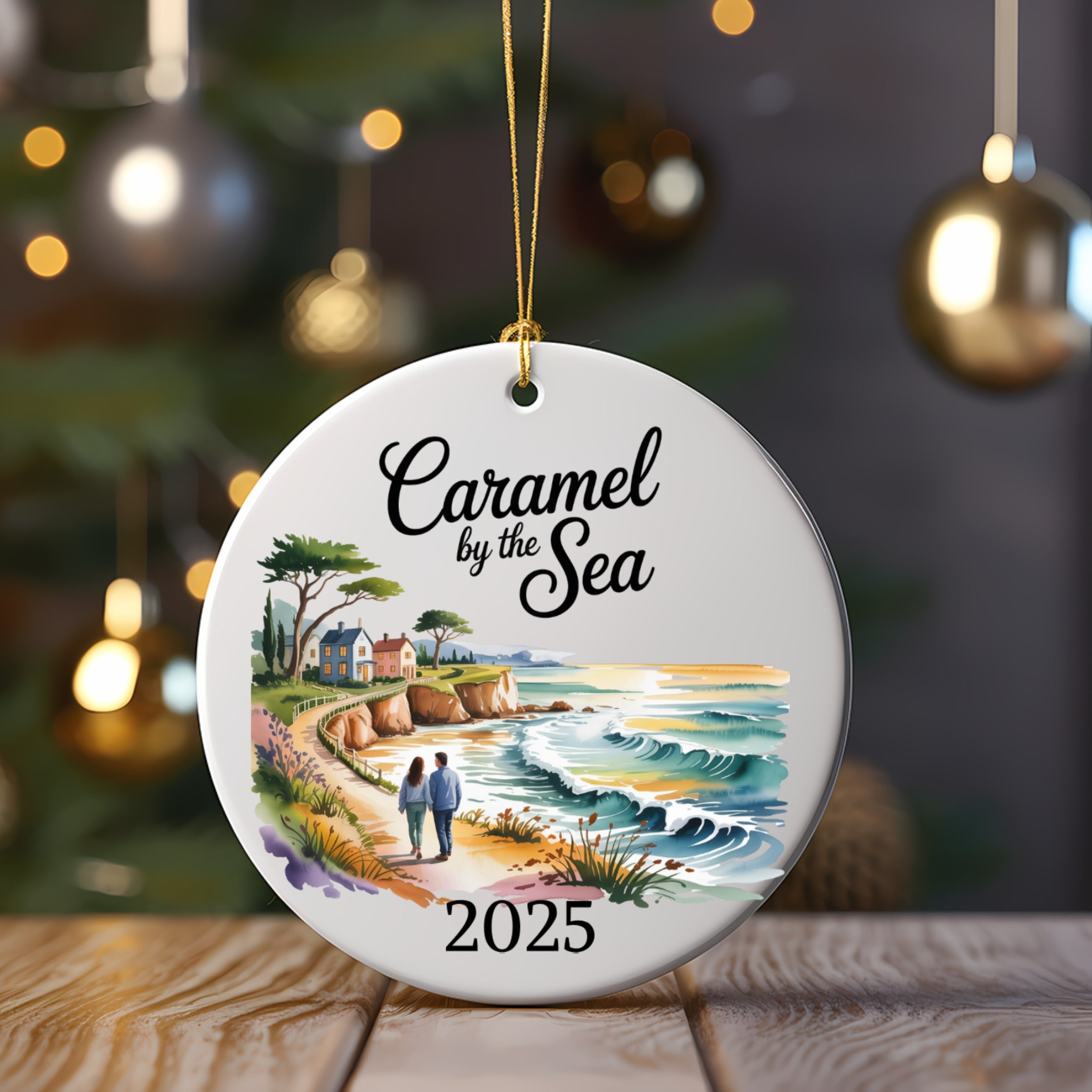 Caramel by the Sea 2025 ornament featuring a coastal scene with a couple.