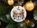 Round ornament with Tokyo pagoda and "2025" text, hangs on Christmas tree.