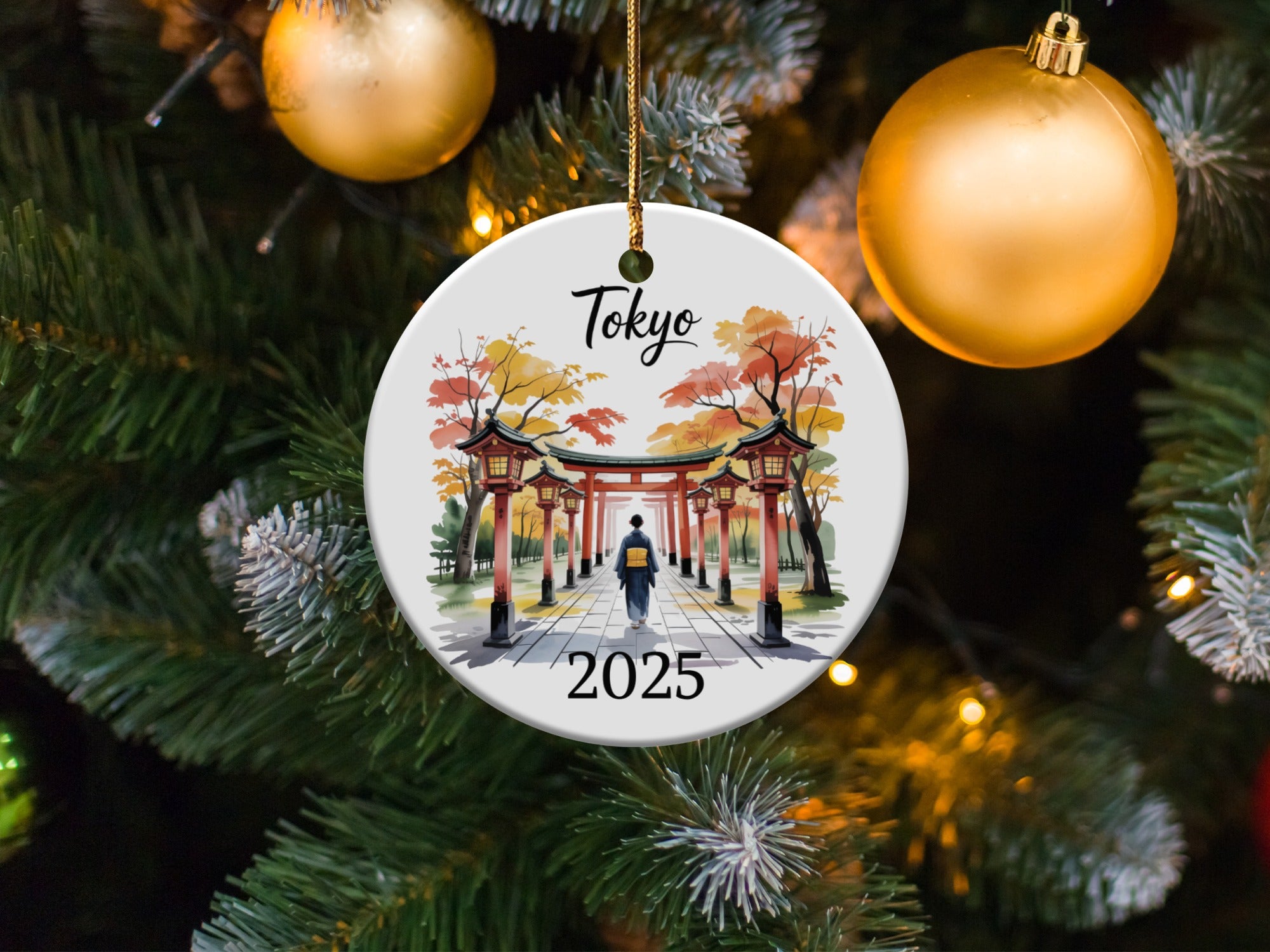 Round ornament with Tokyo pagoda and "2025" text, hangs on Christmas tree.