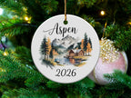 Aspen 2026 ceramic ornament with cabin, lake, and mountain scene.