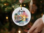 Aruba 2025 round ceramic ornament with beach houses and sailboat.