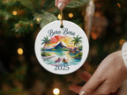 Bora Bora 2025 ornament with palm trees, bungalows, and mountains.