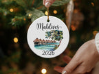 Maldives 2026 circular ornament with overwater bungalows and palm trees.