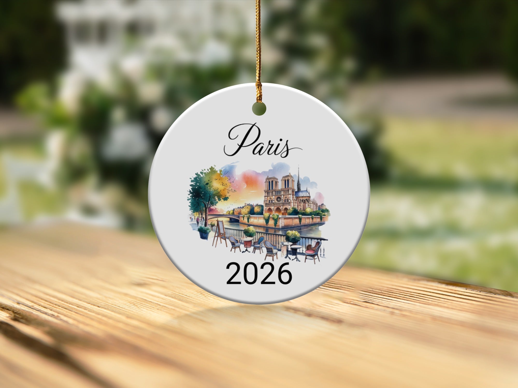 Paris 2026 ceramic ornament featuring Notre Dame Cathedral and river scene.