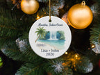 Round ornament featuring a tropical waterfall scene with text: "Mauritius, Indian Ocean, Lisa + John 2026".