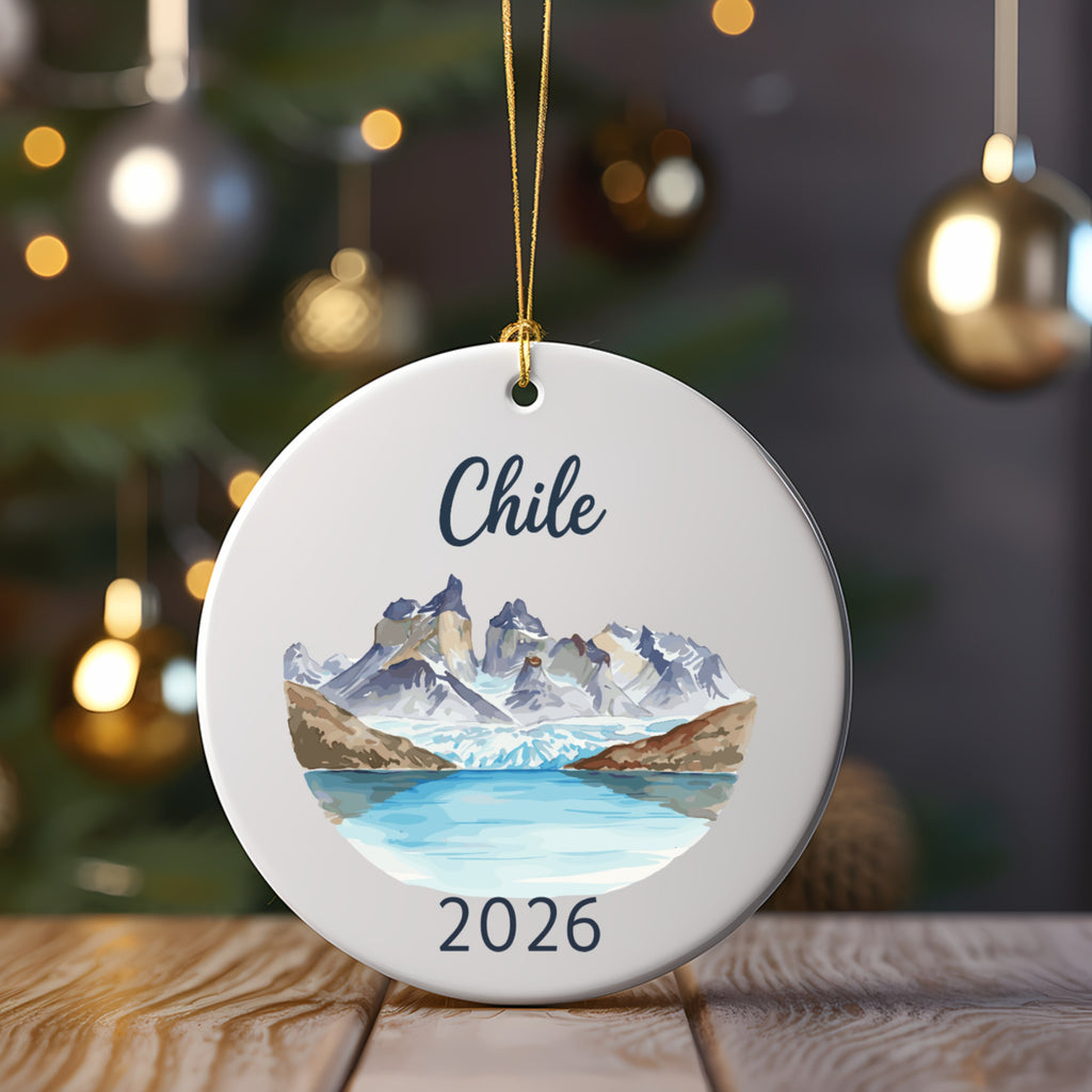 Round ornament with watercolor painting of Chilean mountains and lake, "Chile" and "2026" text.