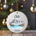 Round ornament with watercolor painting of Chilean mountains and lake, "Chile" and "2026" text.