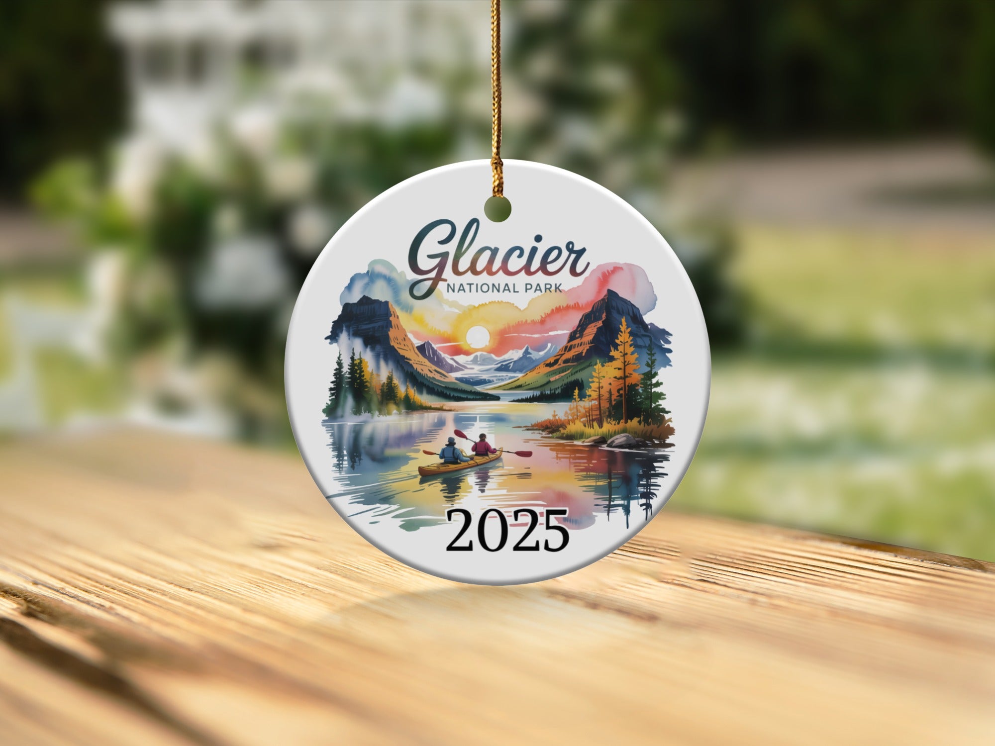 Glacier National Park 2025 round ornament with kayakers on a lake.