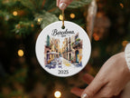Round ceramic ornament with Barcelona street scene and "2025" text.