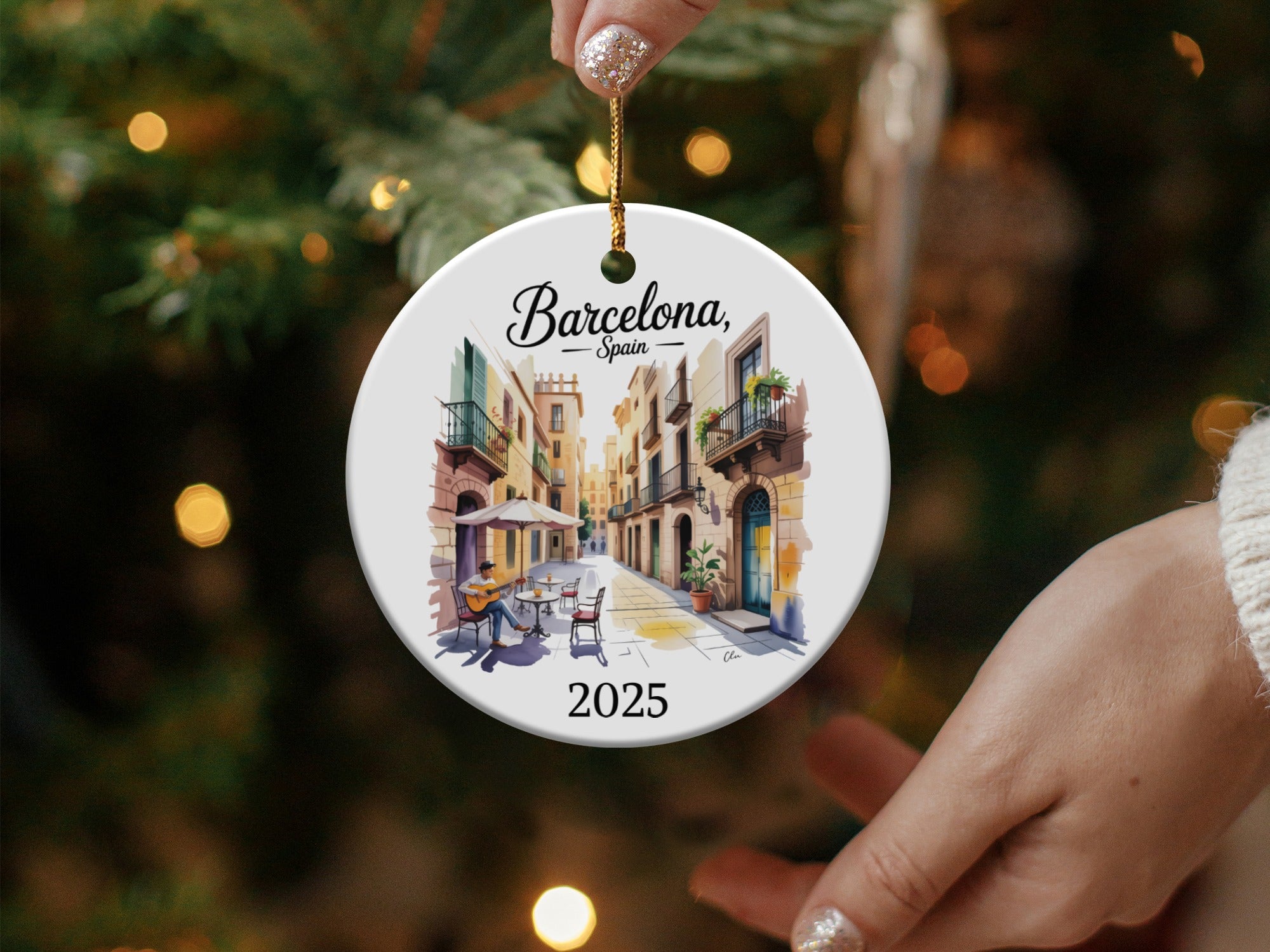 Round ceramic ornament with Barcelona street scene and "2025" text.