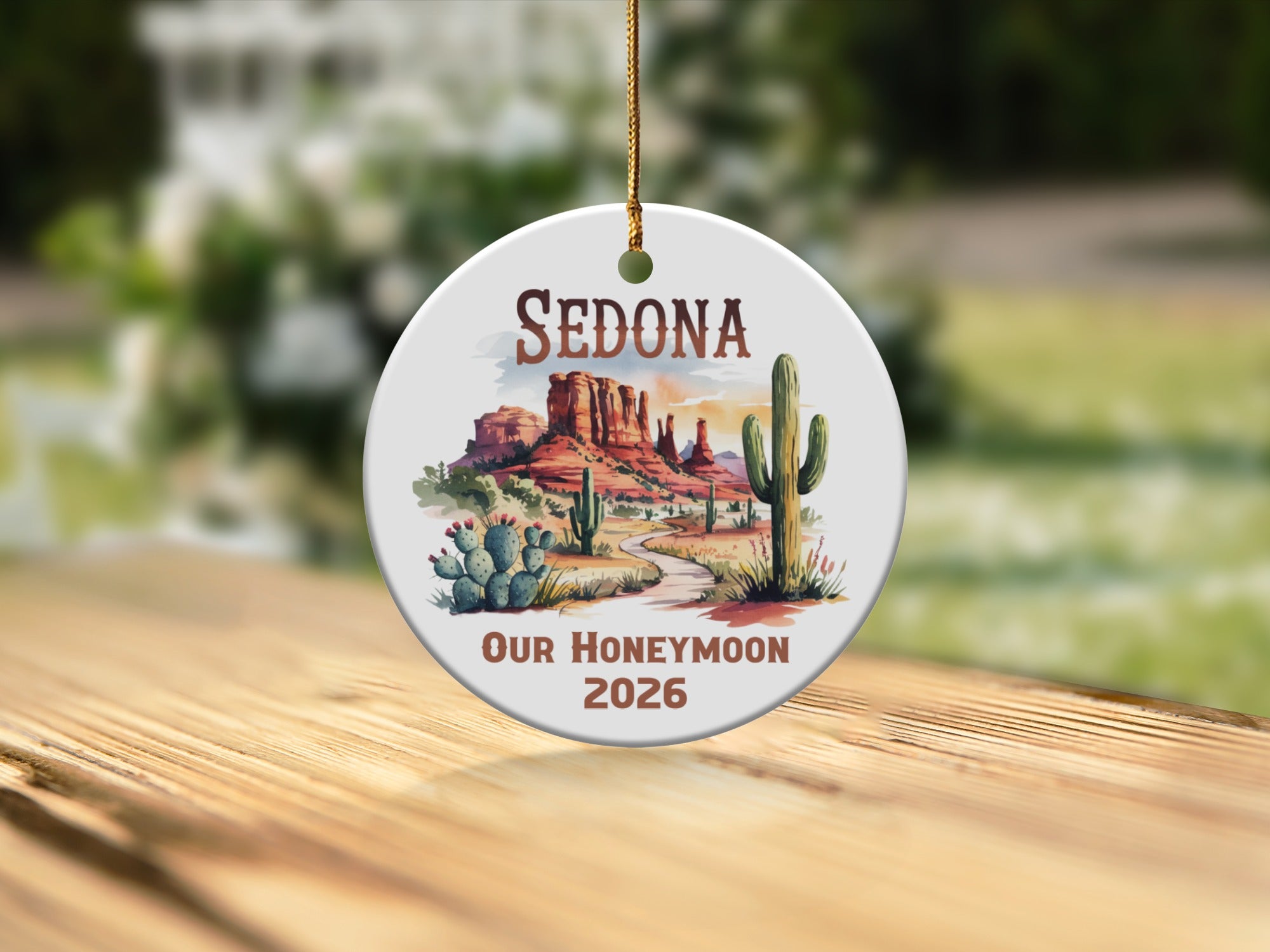 Round ornament with Sedona landscape and "Our Honeymoon 2026" text.