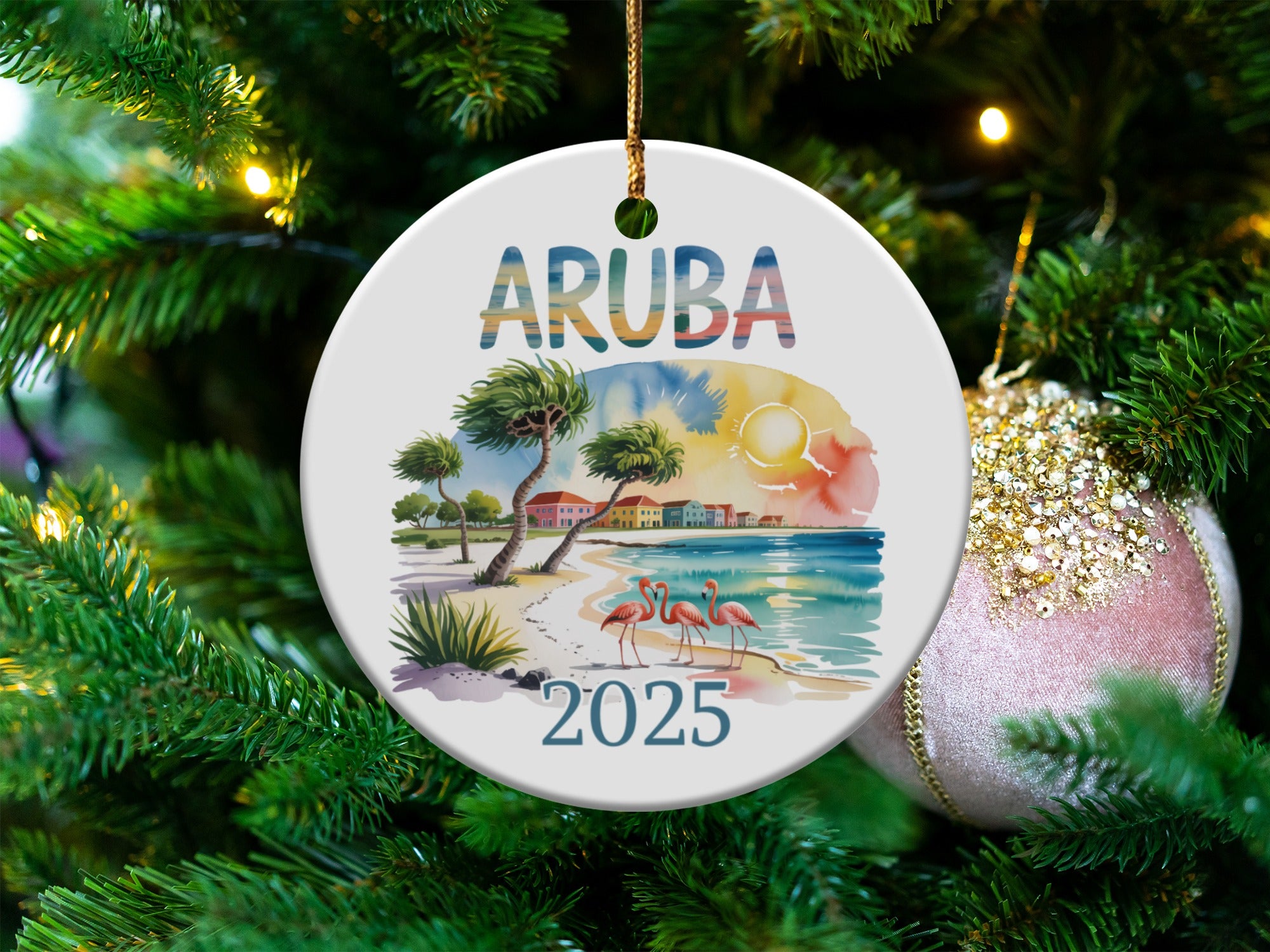 Round ARUBA 2025 ornament with beach scene and flamingos.