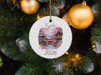 Round ornament featuring a Kyoto scene with a torii gate and cherry blossoms, dated 2026.
