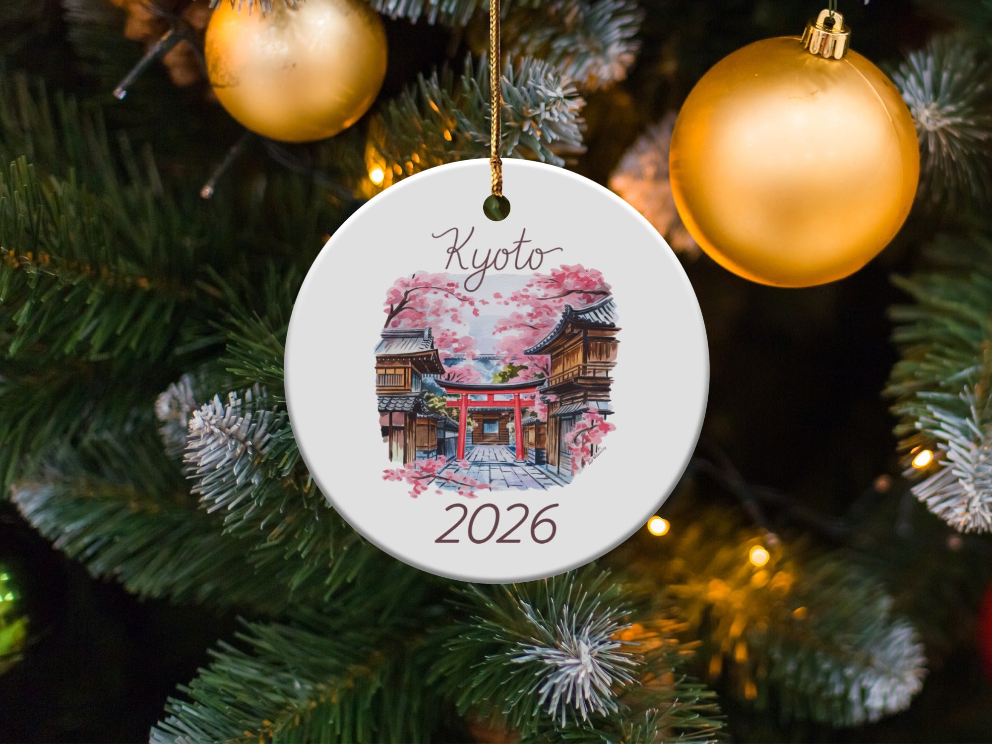 Round ornament featuring a Kyoto scene with a torii gate and cherry blossoms, dated 2026.