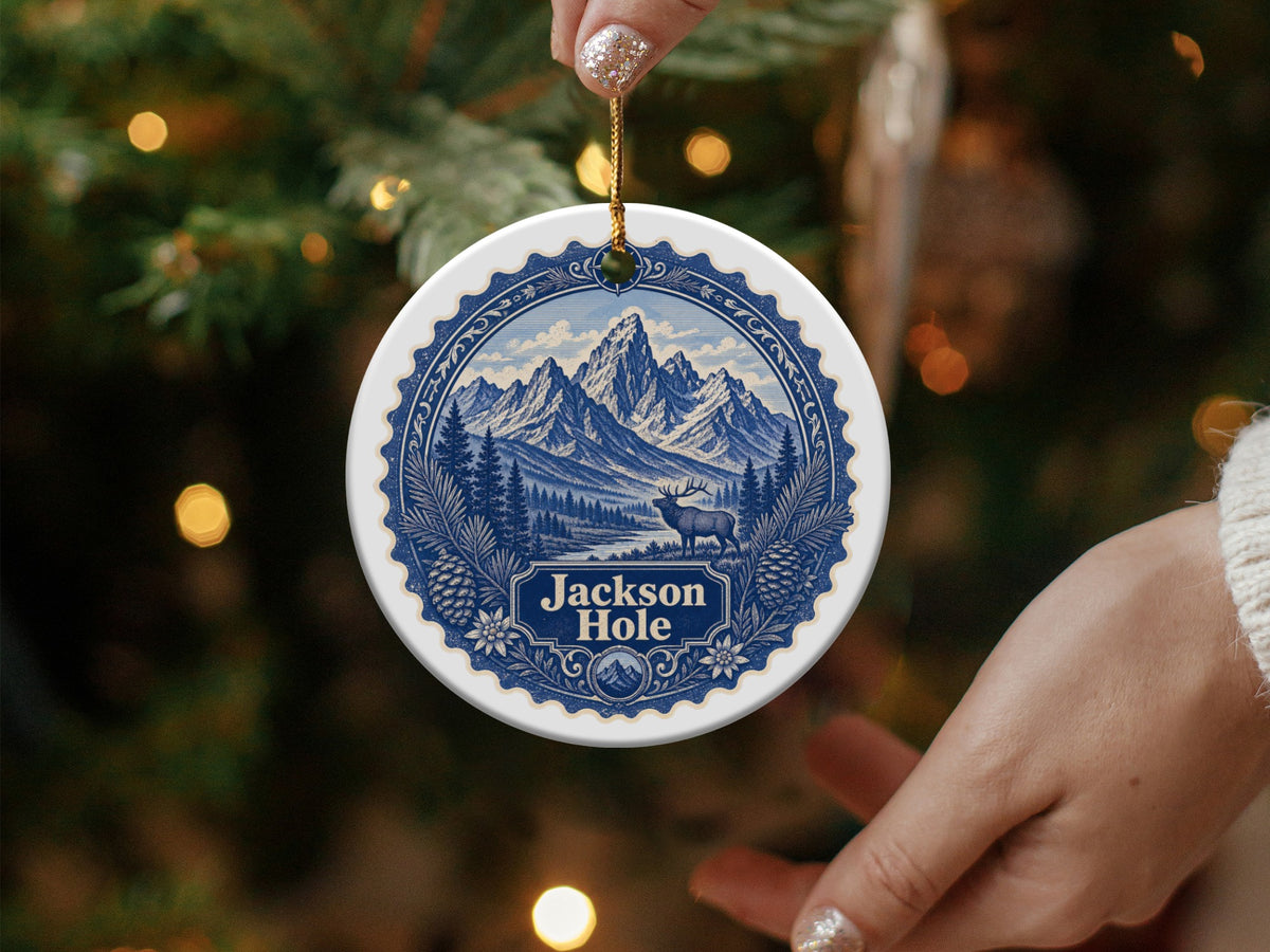 Round Jackson Hole ornament with elk, mountains, and text.