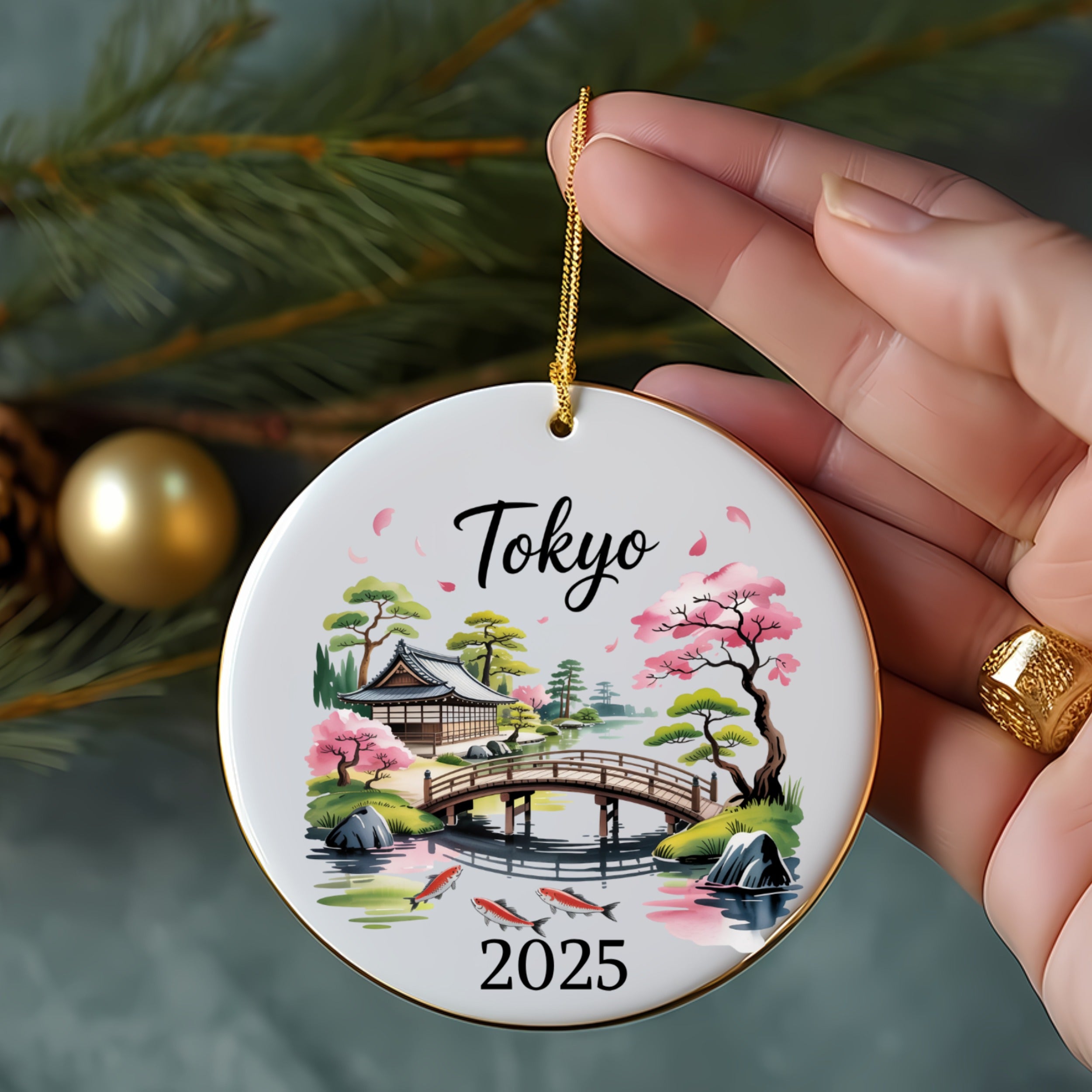 Round ornament with Tokyo and 2025 text, bridge, and cherry blossoms.