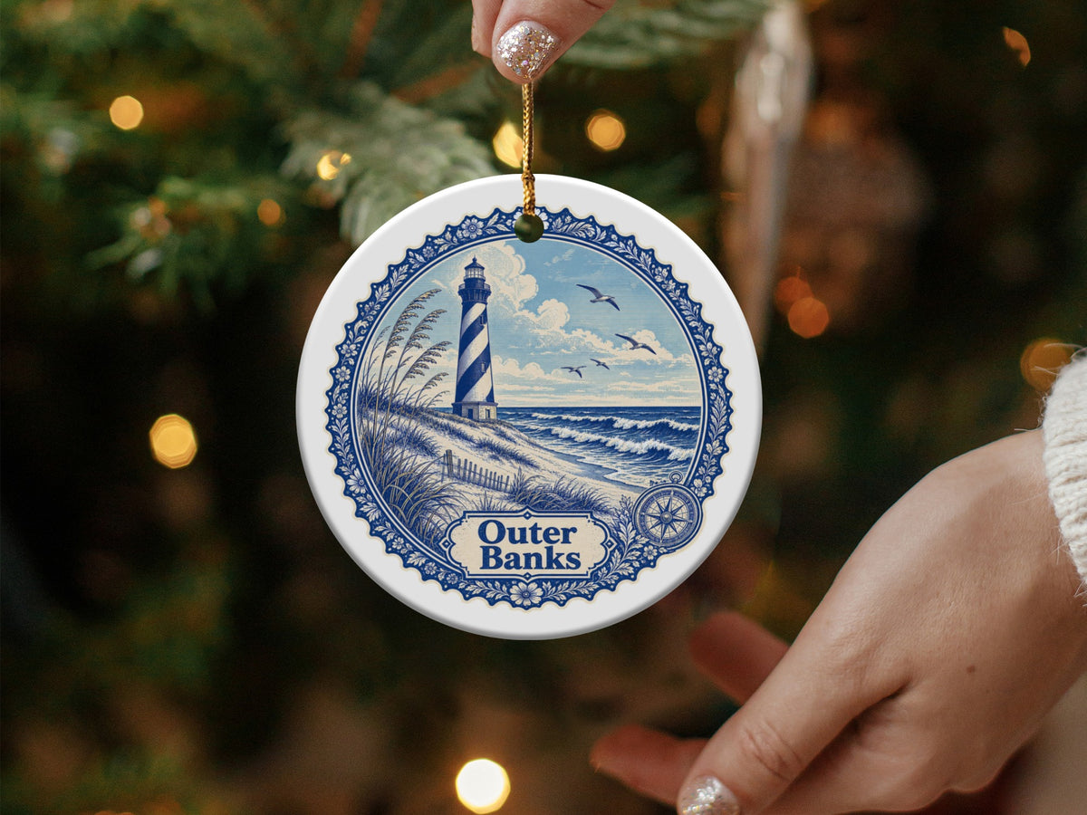 Outer Banks lighthouse ornament on Christmas tree with hands holding it.
