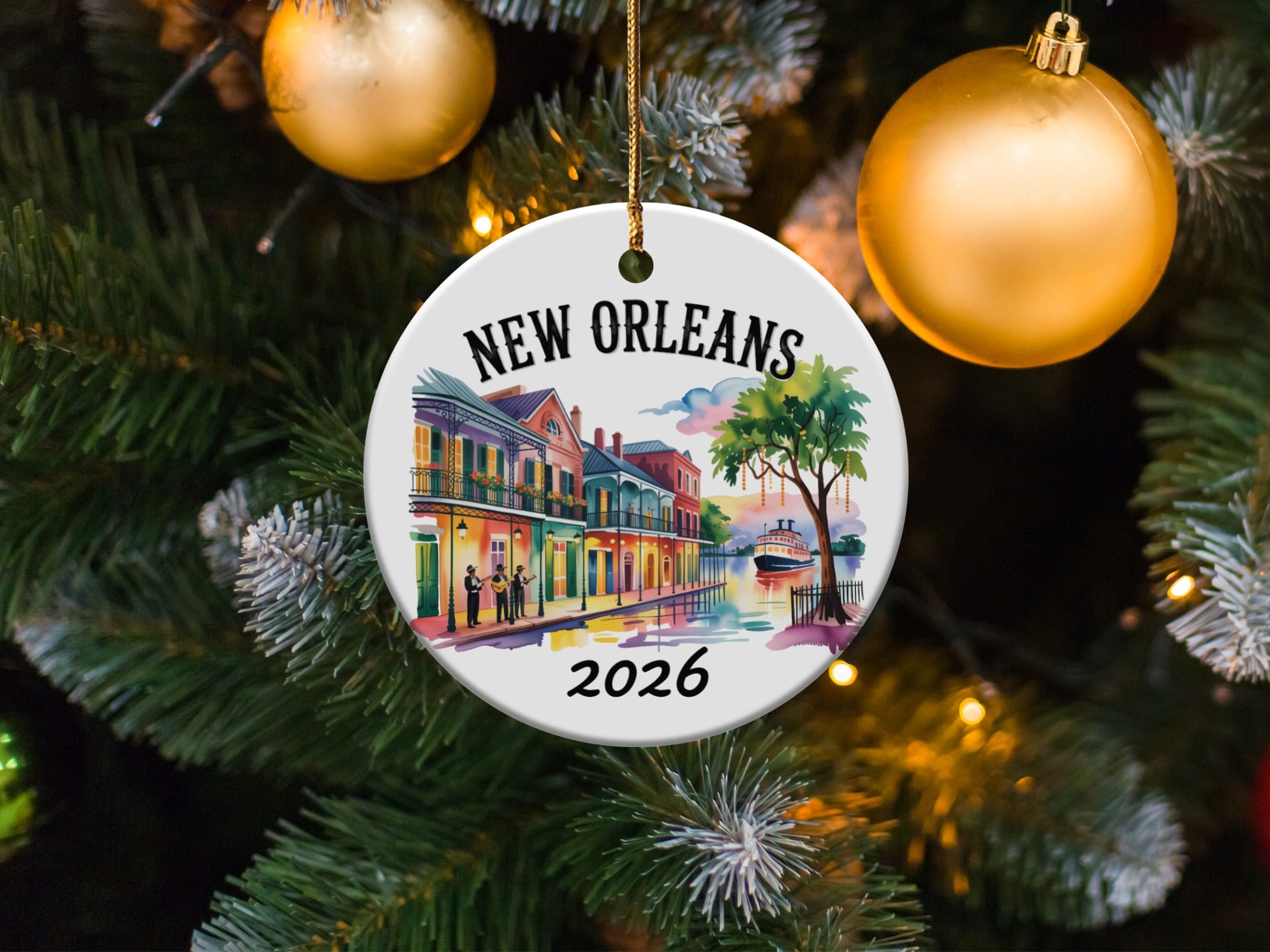 New Orleans 2026 ceramic ornament with buildings and a riverboat on a Christmas tree.