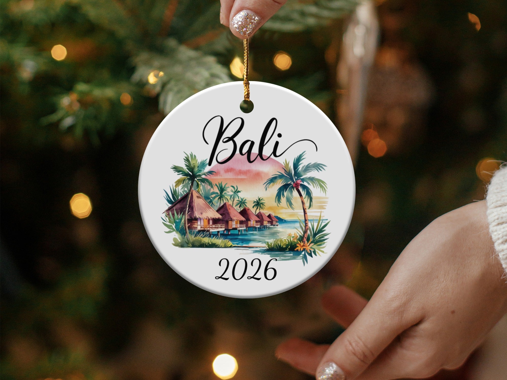 Round Bali ornament with bungalow, palm trees, sunset, and "2026" text.