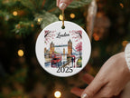 Round ceramic ornament featuring London Tower Bridge, a red double-decker bus, and the year 2025.