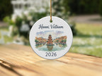 Round ceramic ornament featuring a watercolor scene of Hanoi, Vietnam with text "2026".